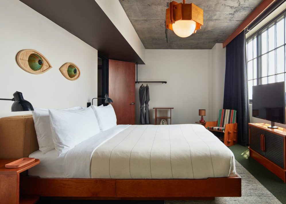 A dedicated bedroom with modern decor, a bar for hanging clothes and multiple light sources
