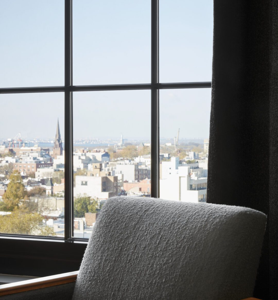 A window on a high floor provides sweeping city views with a Cathedral in the background