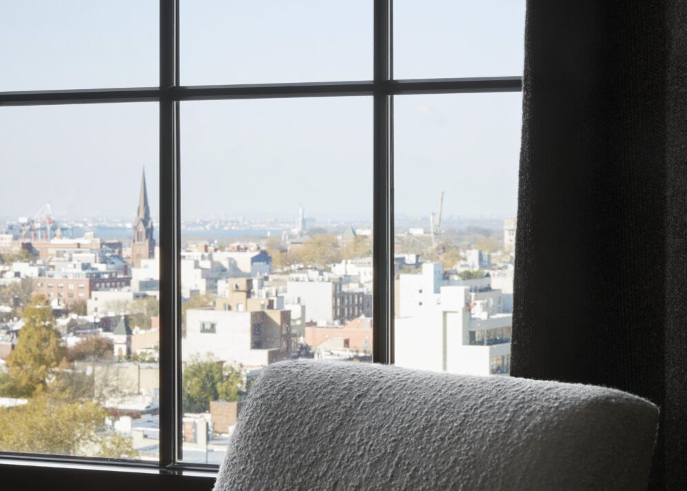 A window on a high floor provides sweeping city views with a Cathedral in the background