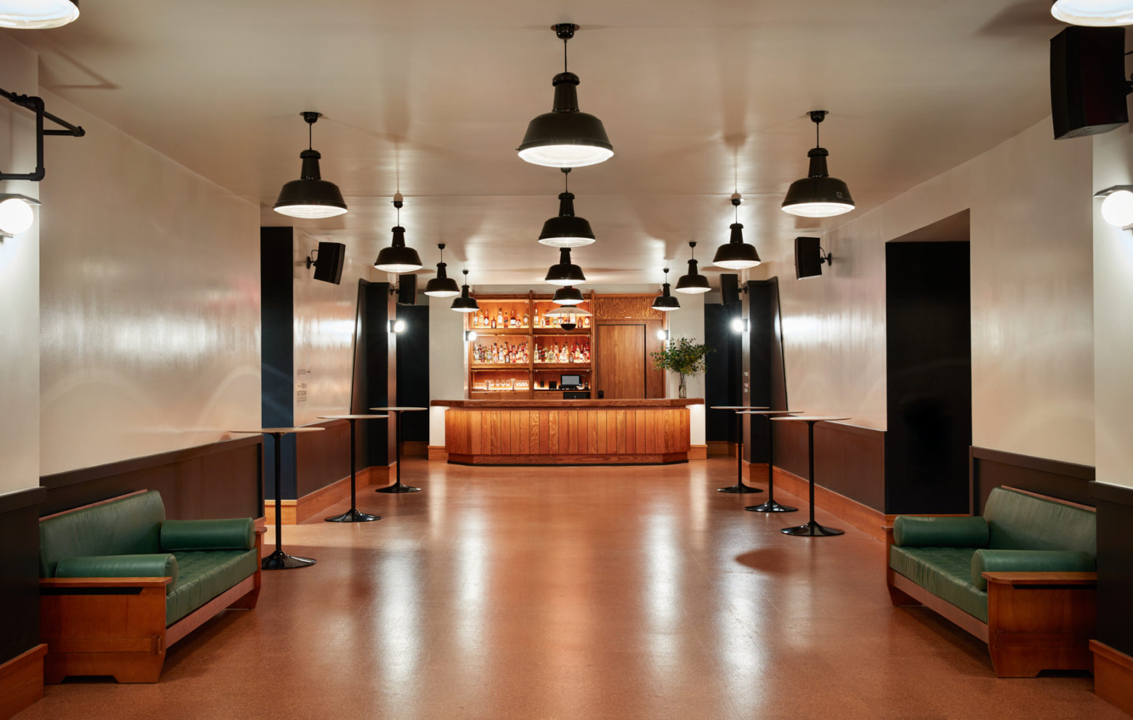 A low ceiling venue with studio style lights and built in seating provides a good place for an intermission or set change