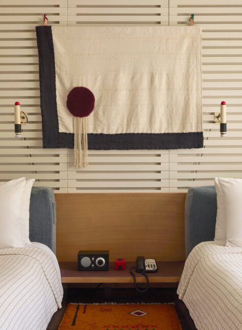 A bluetooth radio and phone sit between two beds