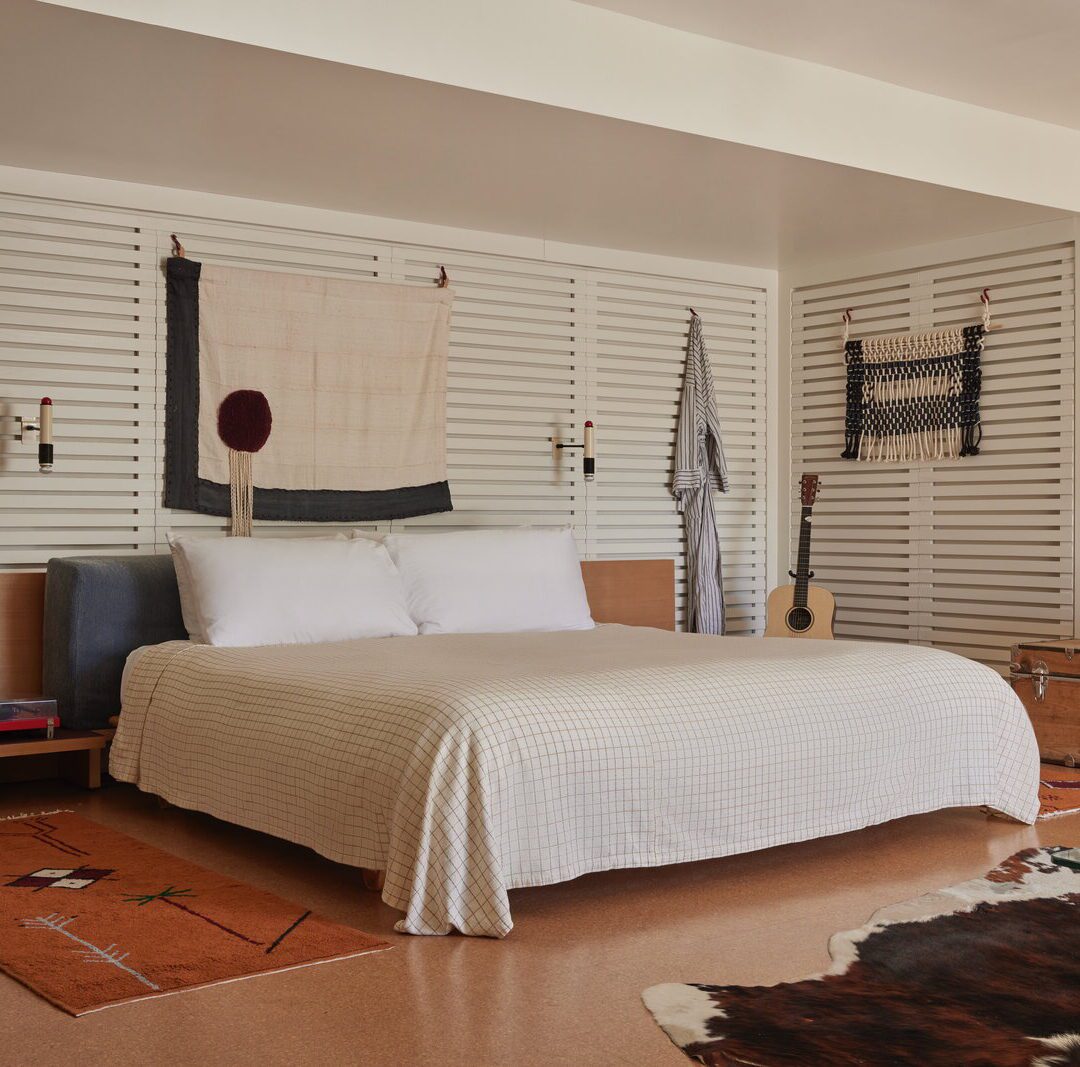spacious king bed is adorned by wall-mounted night lights