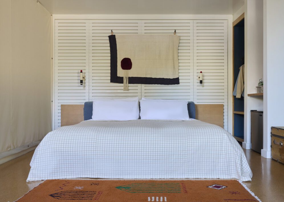 spacious king bed is adorned by wall-mounted night lights
