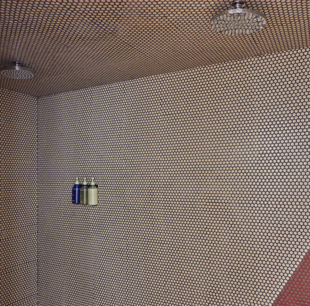 a red and grey tiled shower